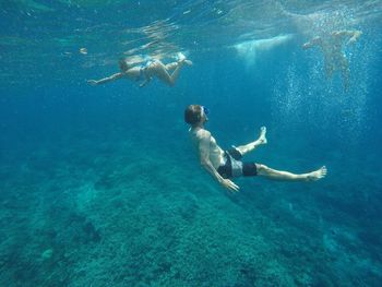 High angle view of men swimming in sea