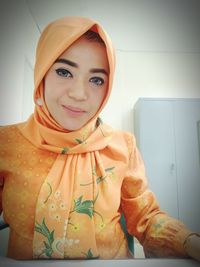 Portrait of smiling young woman at home