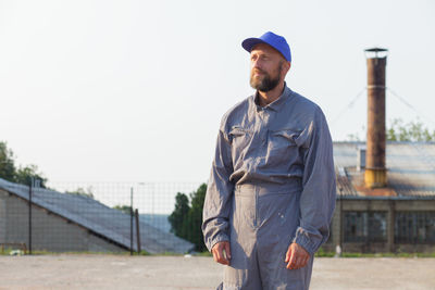 Portrait of man standing against sky