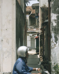 Rear view of people walking on building in city