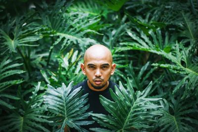 Portrait of man standing against plants