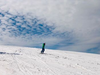 Woman on skiing against sky