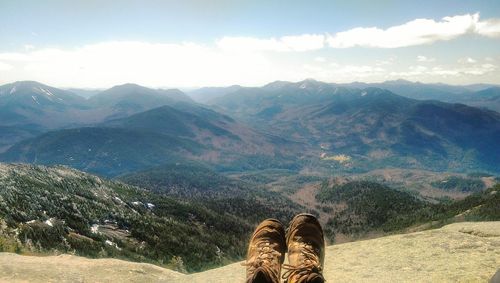Low section of man at adirondack mountains against sky