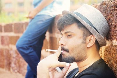 Portrait of young man smoking cigarette