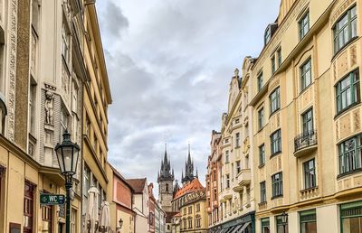 Low angle view of buildings in town against sky