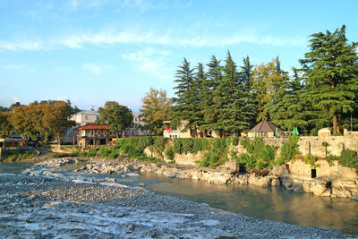 Scenic view of lake and buildings against sky