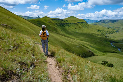 Rear view woman walking on trail