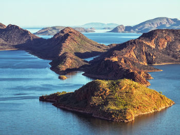 Scenic view of sea and mountains against sky