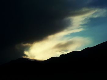 Scenic view of silhouette mountain against dramatic sky