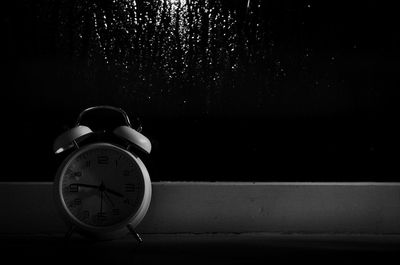 Close-up of clock against black background