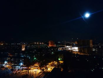 Illuminated cityscape against sky at night