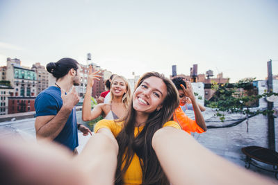 Happy friends on building terrace