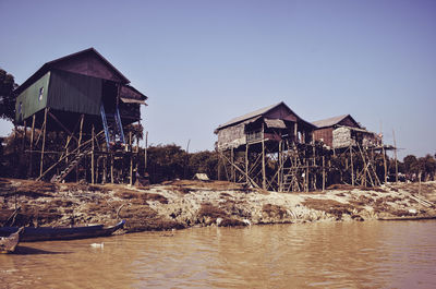 Building by sea against clear sky