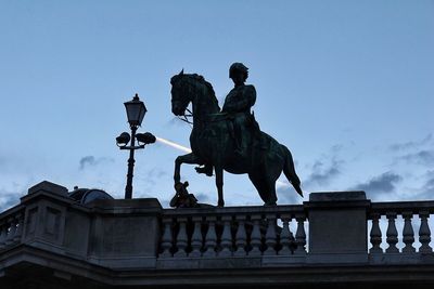 Low angle view of statue against blue sky