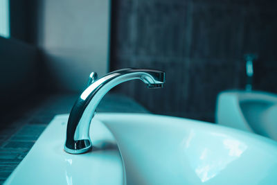 Close-up of faucet in bathroom