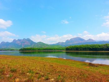 Scenic view of lake against blue sky