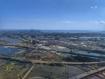 High angle view of river by city against sky