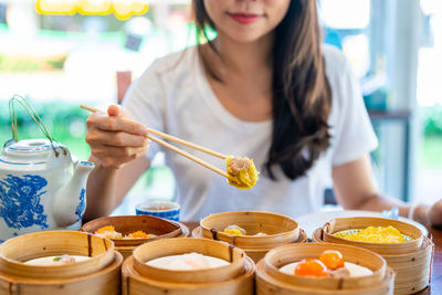 Midsection of woman having food