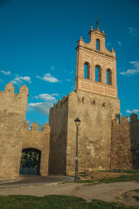 Low angle view of historic building against blue sky