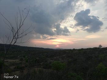 Scenic view of field against sky during sunset