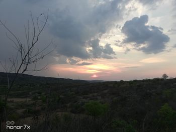 Scenic view of field against sky during sunset