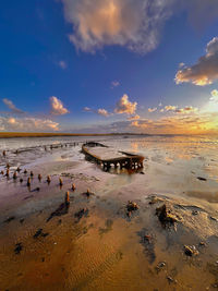 Scenic view of beach against sky during sunset