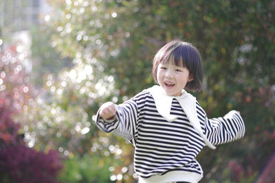 Portrait of smiling boy standing outdoors