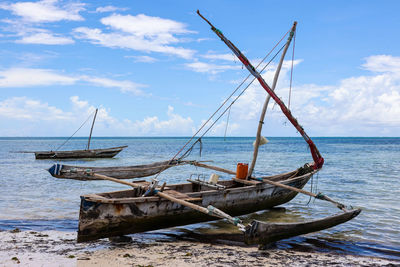 Sailboats in sea against sky