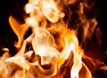 Close-up of fire pit against black background