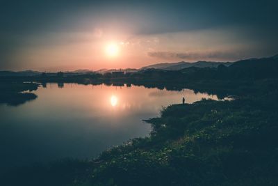 Scenic view of lake against sky during sunset