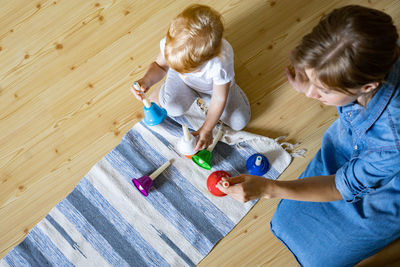 High angle view of boy with toy on floor