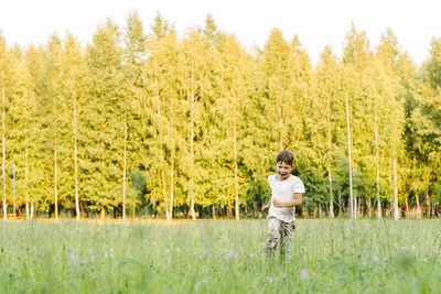 Full length of girl walking on field