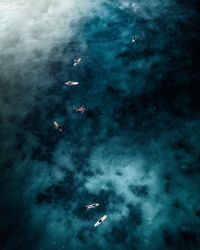 High angle view of people swimming in sea