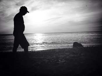 Silhouette of people standing on beach