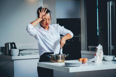 Midsection of woman standing on table