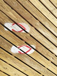 High angle view of umbrella on wooden plank