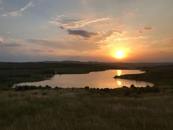 Scenic view of lake against sky during sunset