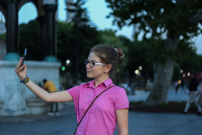 Portrait of young woman using mobile phone