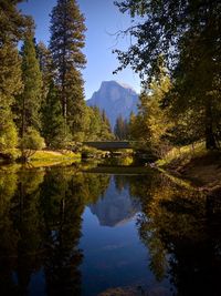 Scenic view of lake by trees against sky during autumn