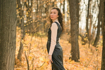 Young woman standing in forest