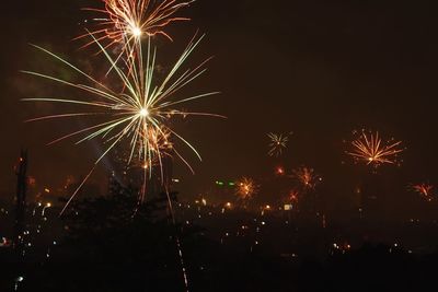 Low angle view of firework display at night