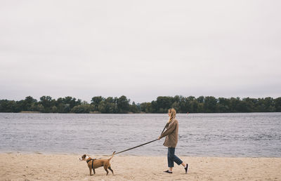 Woman with dog on the beach