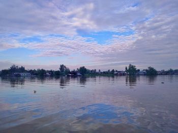 Scenic view of lake against sky at sunset