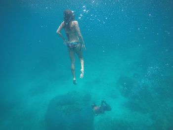 Young woman swimming in sea