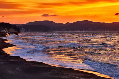 Scenic view of sea against orange sky