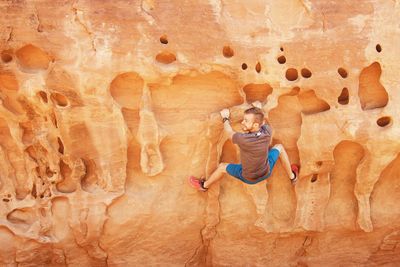 Full length of man climbing on rock