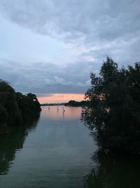 Scenic view of lake against sky at sunset