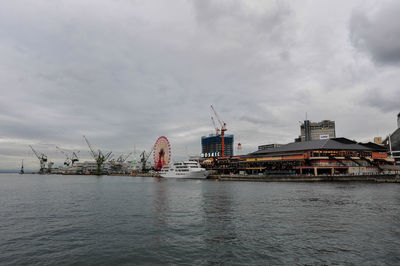 View of city by sea against sky