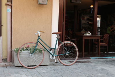 Bicycle against building in city