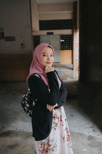 Portrait of young woman looking at camera